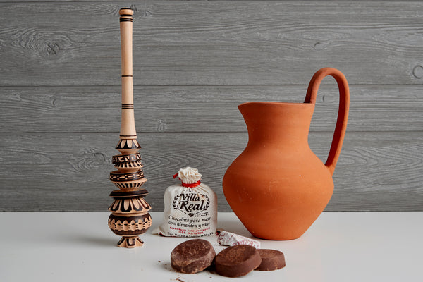 alt="Mexican hot chocolate gift set including red clay jug, chocolate tablets and alder wood molinillo whisk"