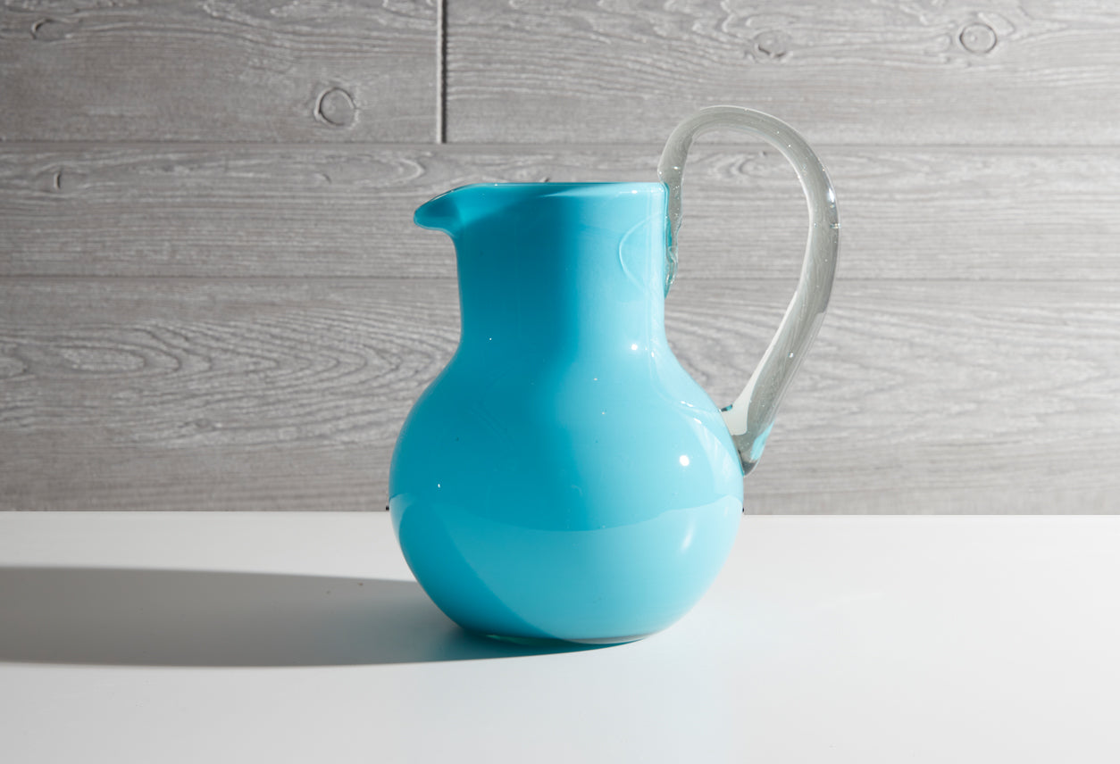 Blue glass pitcher and cups with gold handles for the modern kitchen