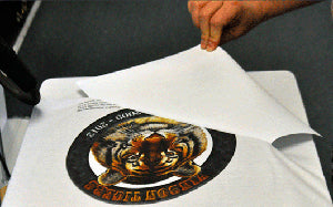 Peeling transfer paper from printed garment transfer