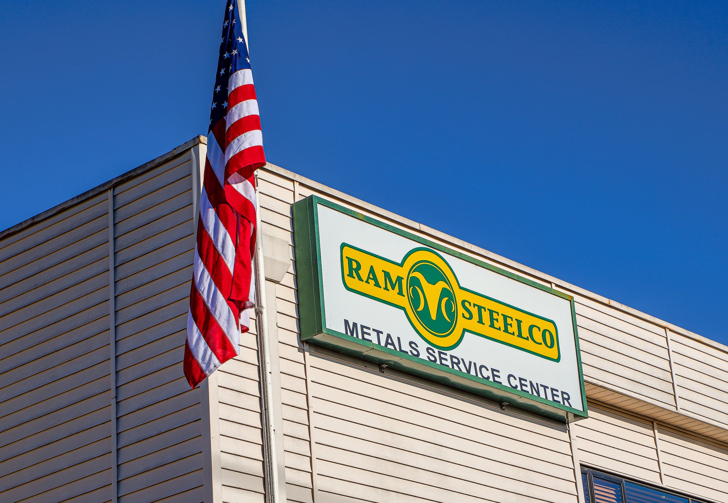 Ram Steelco's warehouse with American flag.