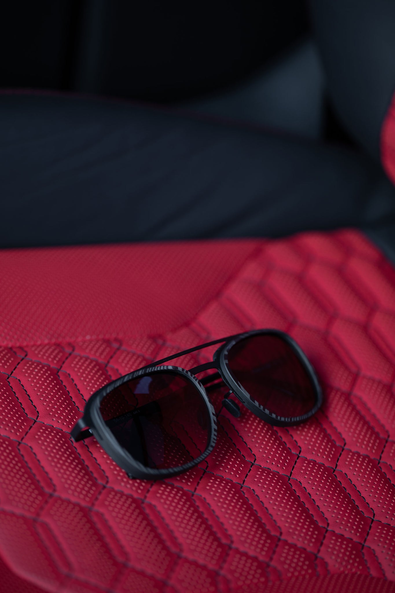 Roveri Eyewear RV018B aviators carbon fiber sunglasses on Lamborghini Urus leather seat.