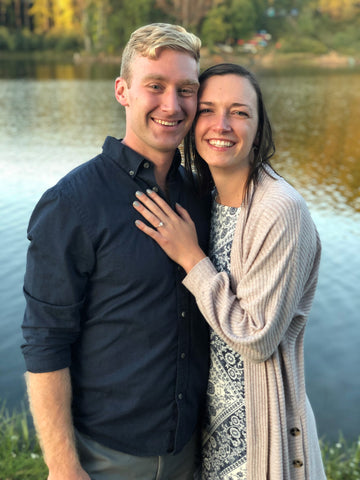 Photo of Engaged Couple Beside a Pond