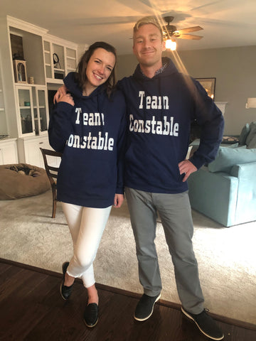 Couple Wearing Team Constable Sweatshirts