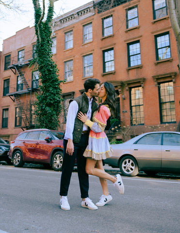Engagement Photo of Maya and Luigi in Front of Apartment Building