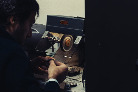 Man using professional jewelry polishing machine to clean ring