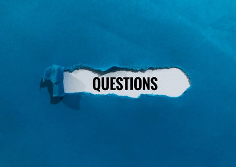 "Questions" under ripped piece of paper