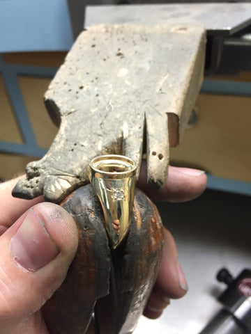 Ring repair holder while jeweler repairs ring
