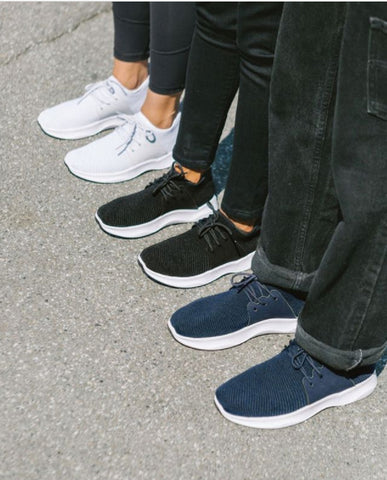 Image of three people’s lower bodies with different pairs of Vessi shoes on
