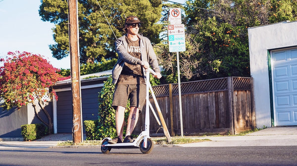 man-riding-electric-scooter