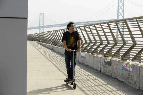 man-urban-scooter-rider-bridge