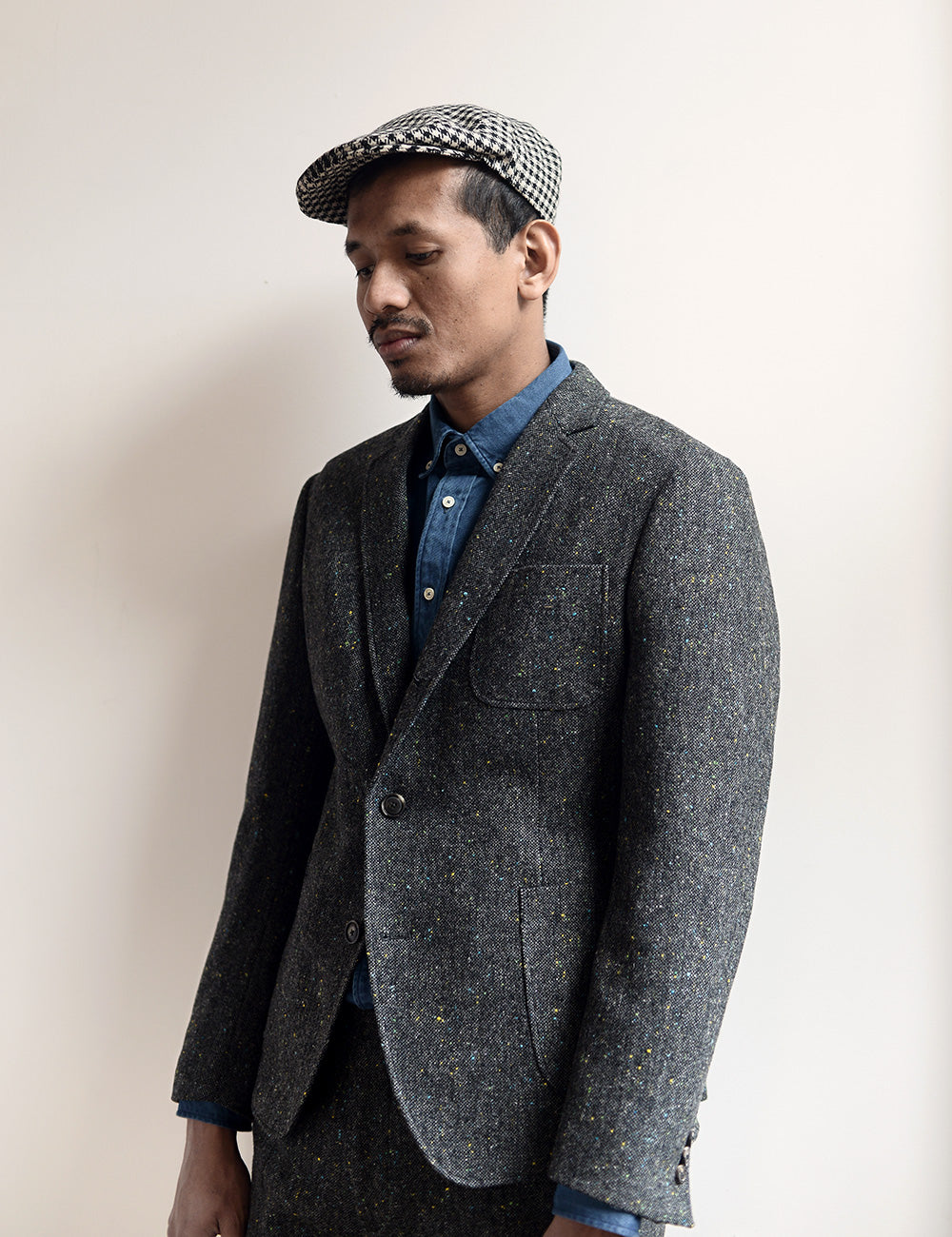 Model wears Donegal tweed unstructured blazer, chambray shirt, and houndstooth hat.
