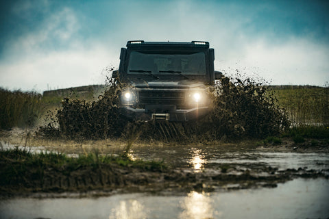 A Jeep going through a swamp