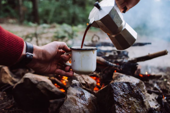 pouring-coffee-over-campfire