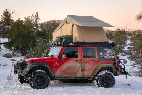 roof-top-tent-mounted-on-red-jeep