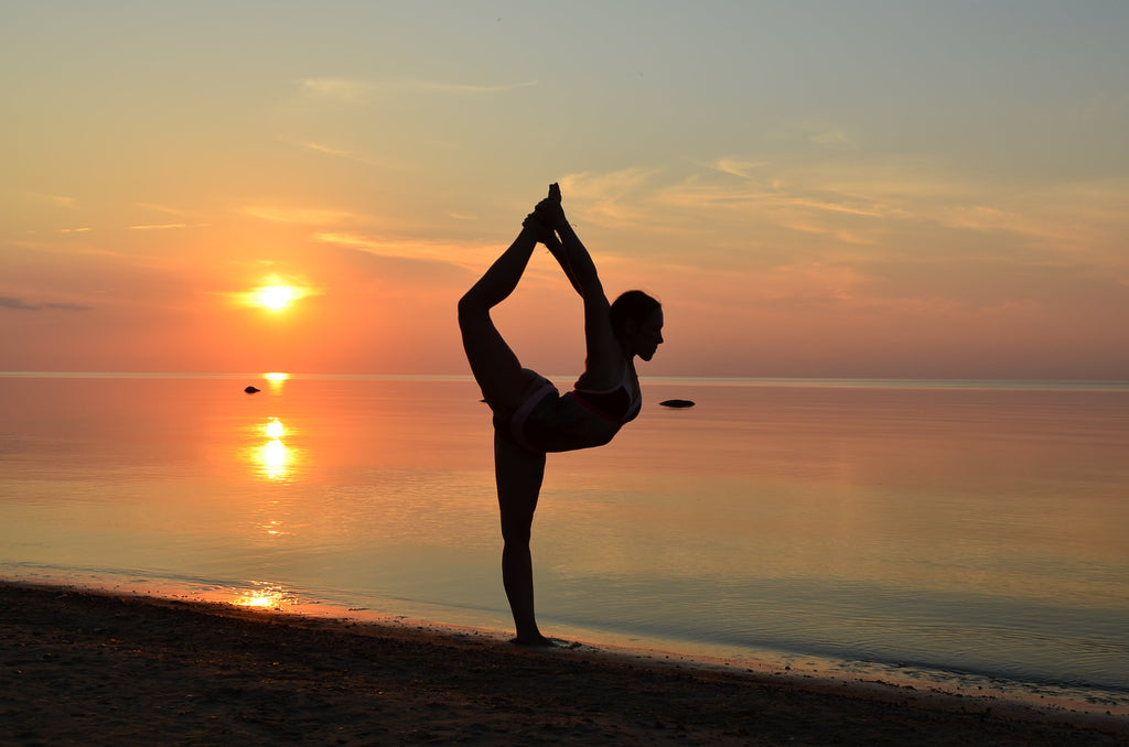 woman-on-beach-nude-yoga-pose-in-sand-at-sunset