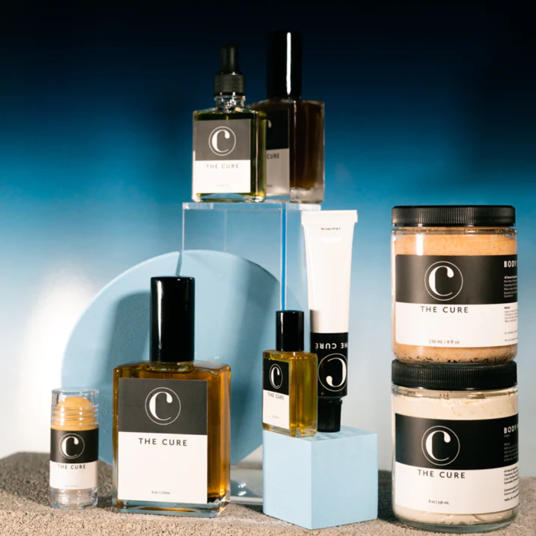 The Cure Skincare's product line, styled on a blue background