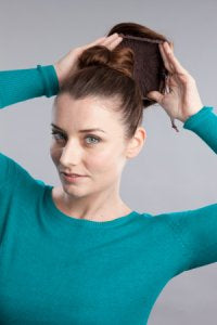 Place the bun hairpiece over the knot, and tie with the hairpiece's cord