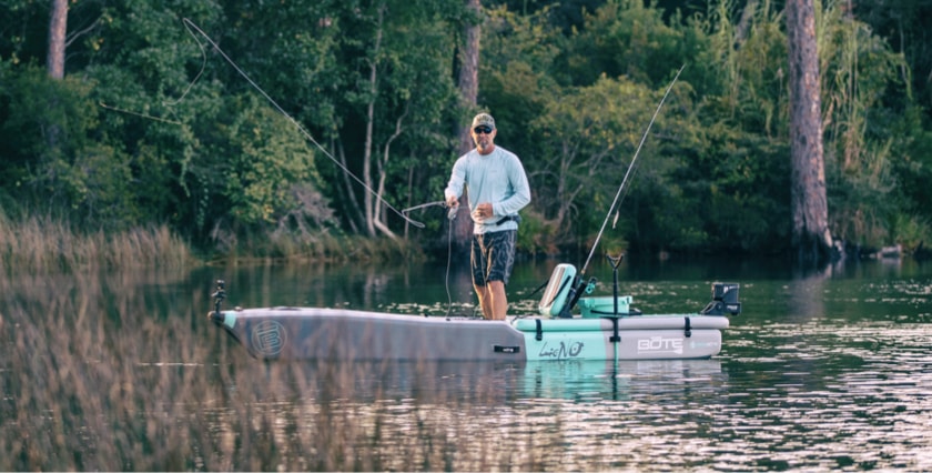 Man standing and fishing from his BOTE LONO Aero inflatable fishing kayak.