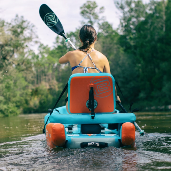 Woman paddling the DEUS Aero inflatable sit-on-top kayak,