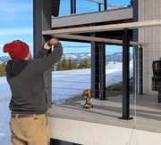 A man installing a cable railing