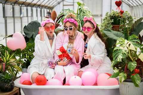 Maegen, Lauren, and Heather in a tub surrounded by balloons in the Appalachian Standard greenhouses