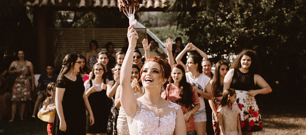 Bride throwing bouquet at wedding