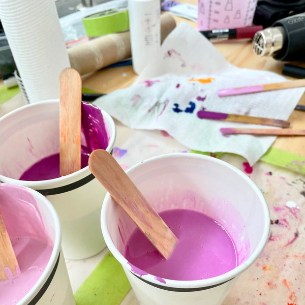 image of three paper cups with various pink resins in them, ready to be poured