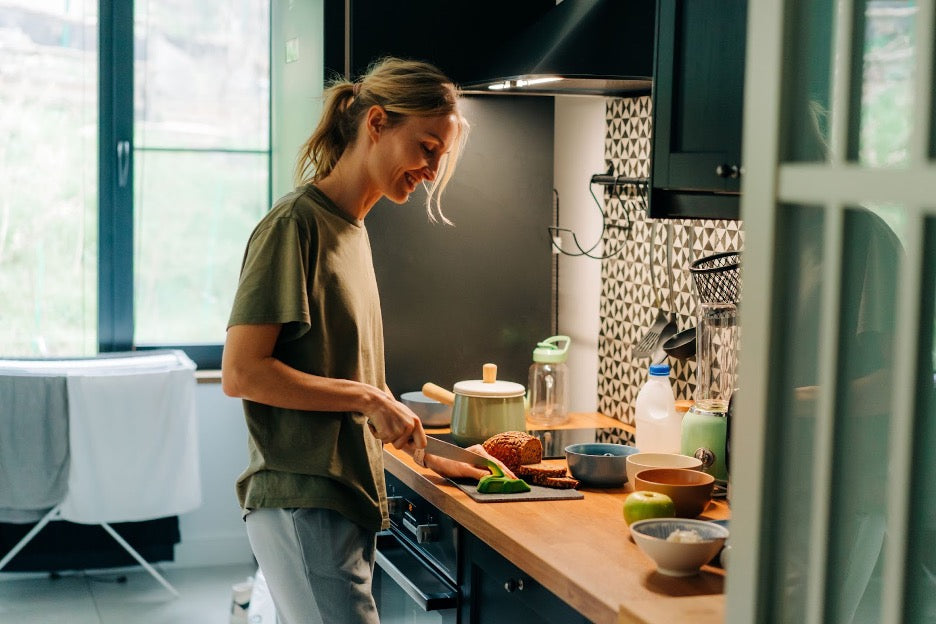 A person preparing meal prepped meals.