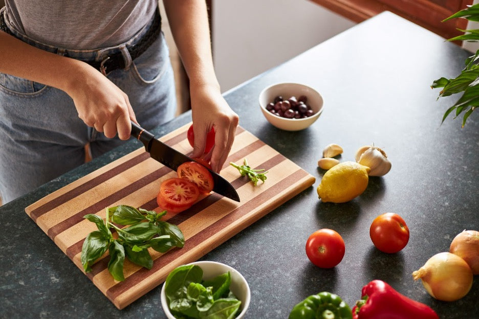 A person chopping tomatoes.