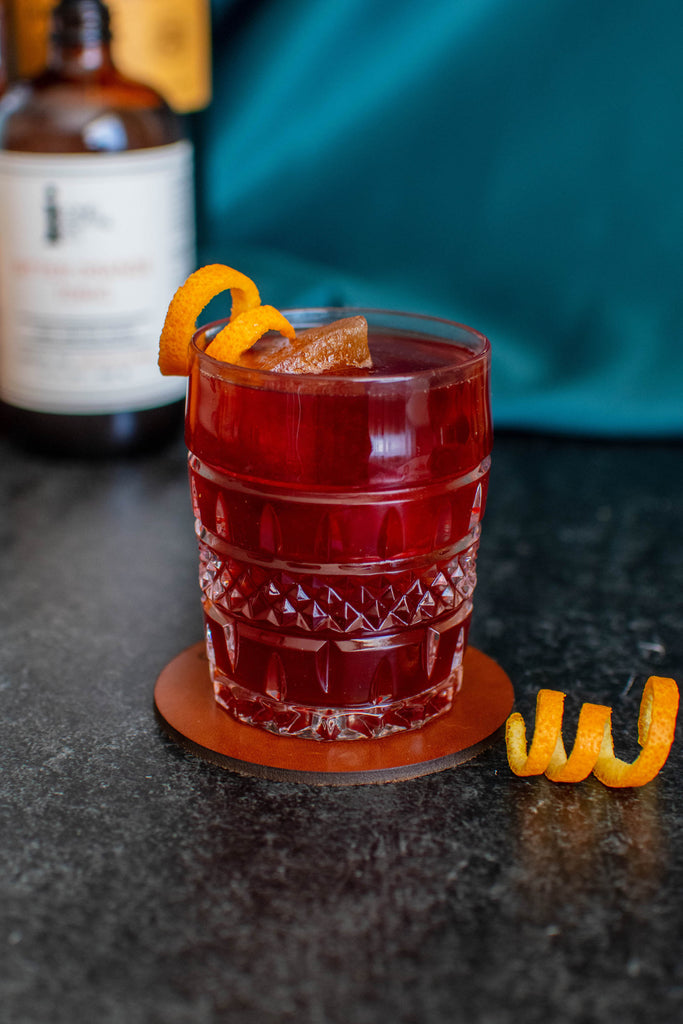 A Boulevardier made with Iconic Bitter Orange Tonic and a unique cold brew coffee ice cube for a new take on the classic. 