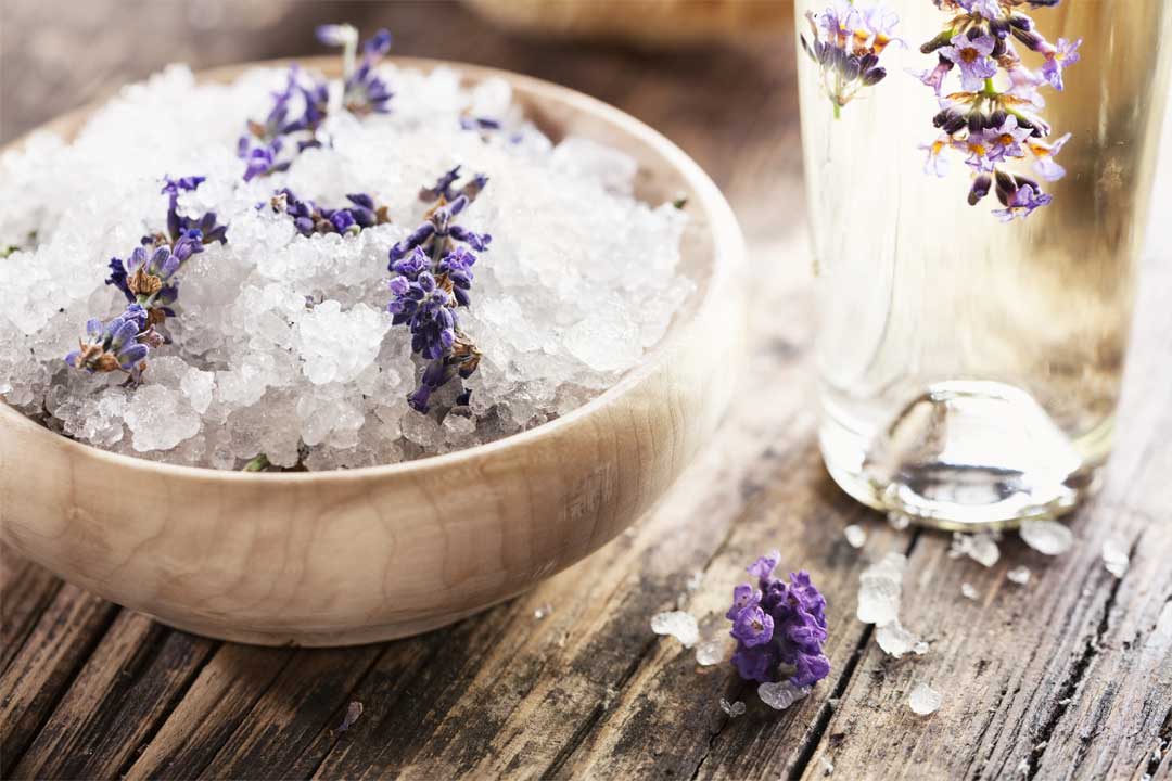 A bowl of purple lavender in epsom salt for a foot soak - Purely Northwest