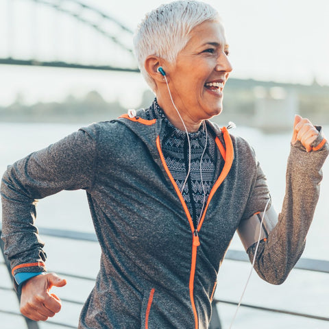 a older woman running with earphones in