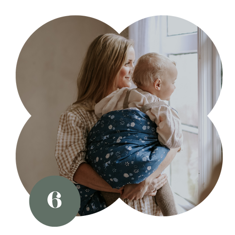 Mom holding baby with a gooselings duvet