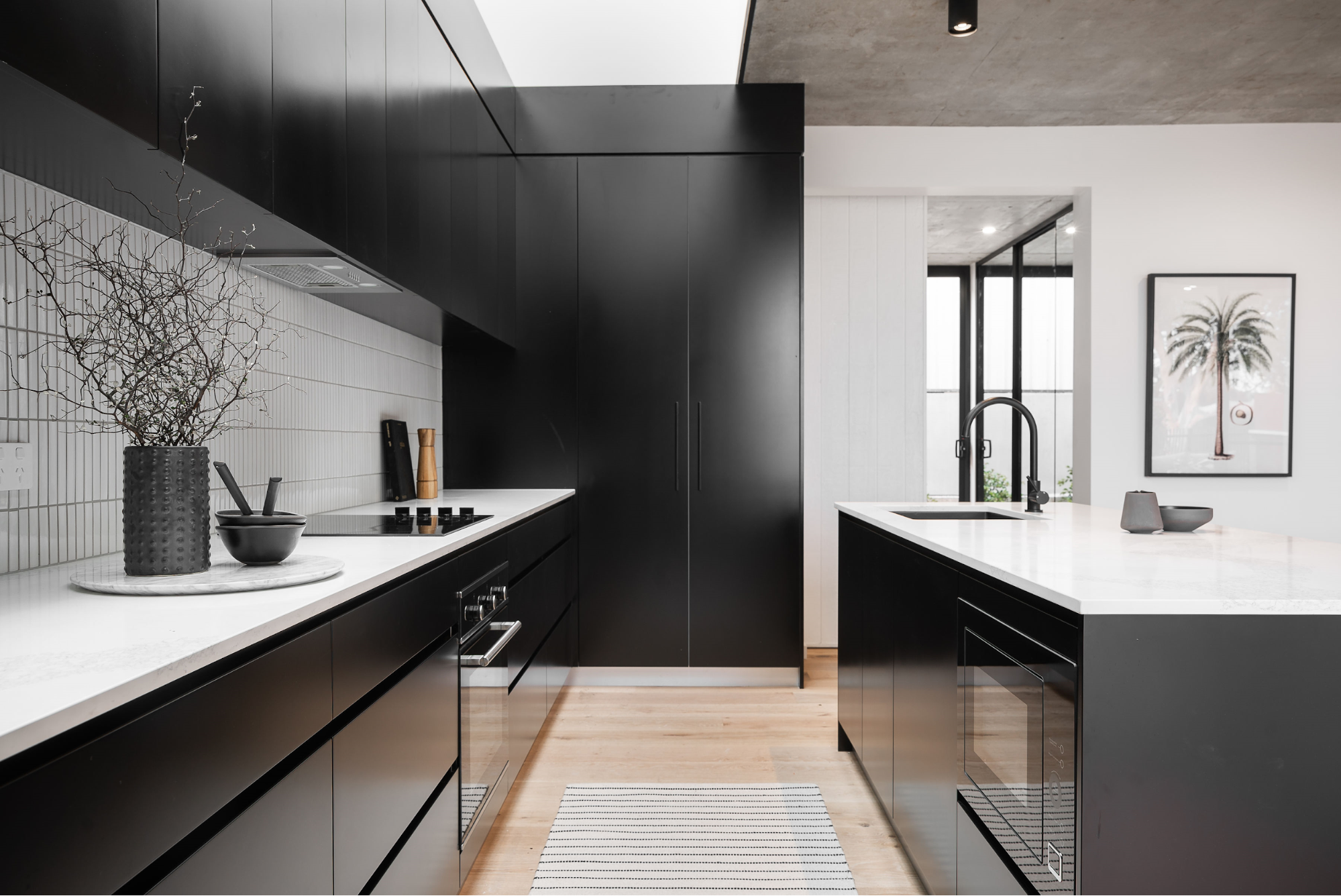 Modern kitchen with premium matte black tapware and gunmetal kitchen sink by Meir