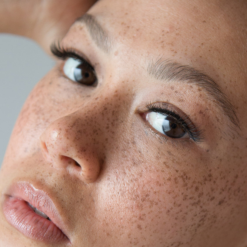 Blog_Lithe Lashes_ Lash Extensions vs. Strip Lashes_Third Image_Face shot of beautifully freckled model, wearing Lithe Lashes