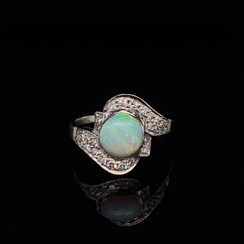 Vintage Platinum Ring featuring a bezel set Round Opal Cabochon with 28 single cut diamonds wrapping the opal in a curved fashion down the arms. Art Deco quality. Size 6.5