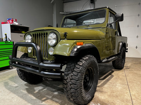 Front of the newly restored Jeep Scrambler inside the new shop