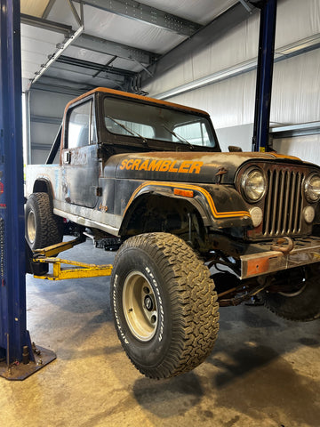 Jeep Scrambler on the lift at the start of the project