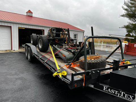 a Jeep CJ5 Golden Eagle in pieces loaded onto a trailer