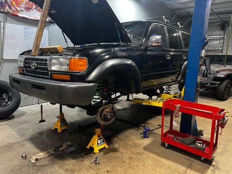 a Landcruiser being worked on on a lift