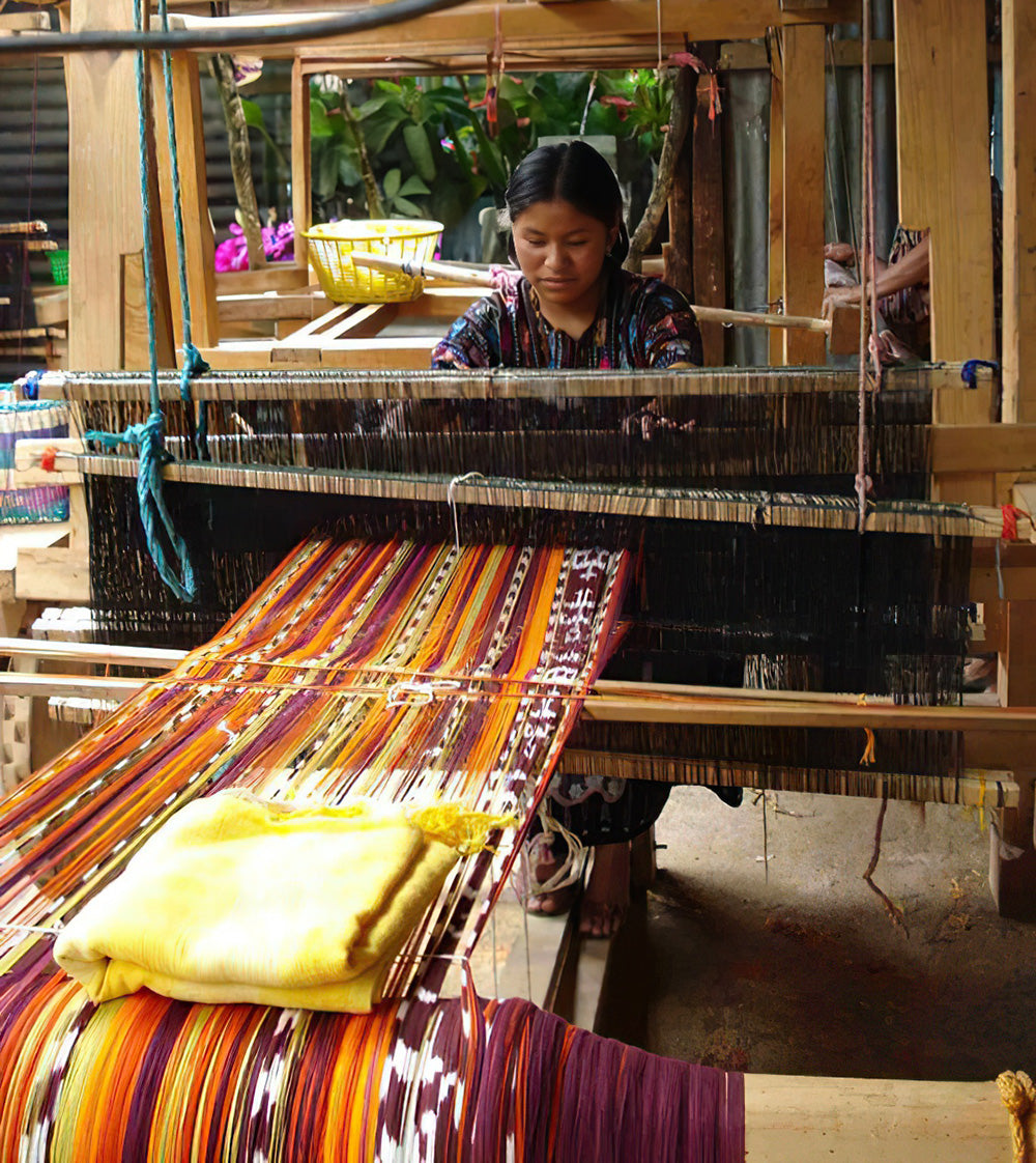Guatemalan Mayan woman weaving textiles on a foot loom