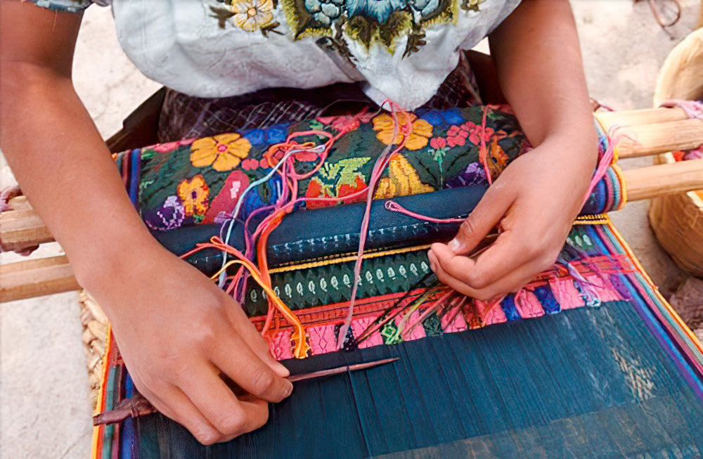 Guatemalan Mayan woman weaving a huipil textile