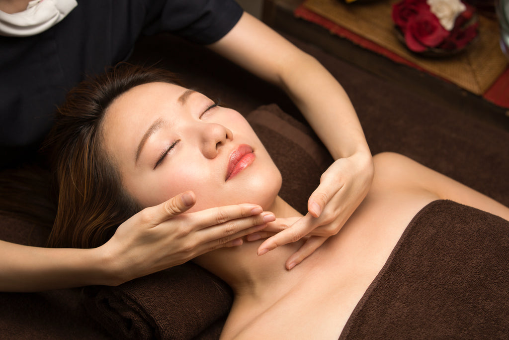 Asian woman receiving spa treatment. 