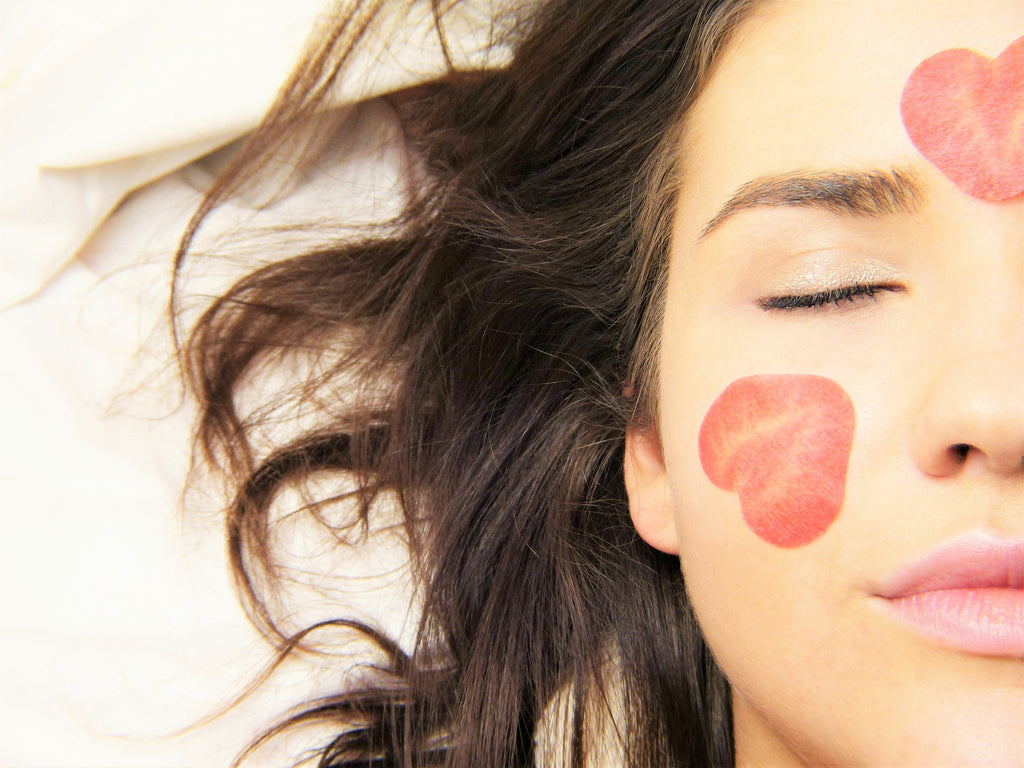 Brunette with beautiful skin filled with heart-shaped kisses