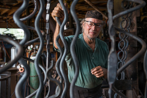 Christopher Thomson, a New Mexico Blacksmith standing in his blacksmith studio.