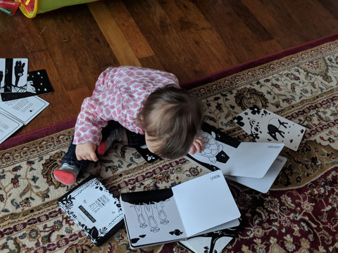 toddler looking at black and white board book