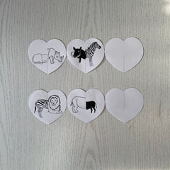 2 strips of 3 cut out paper hearts that are joined featuring animal illustrations