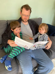 Dad reading to two children