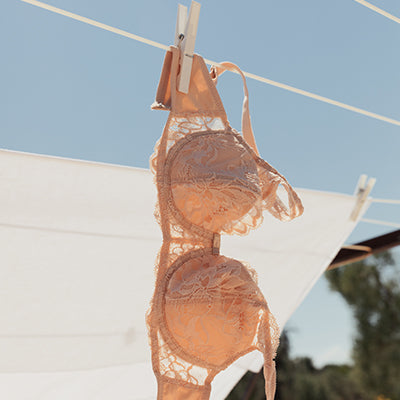 Bra pegged to clothesline, sustainably drying in the wind
