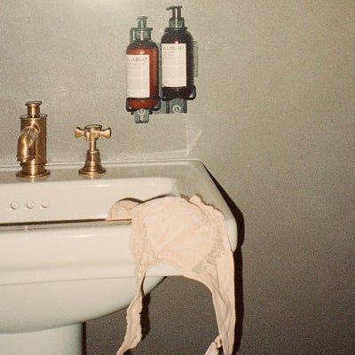 Bra draped over white sink, ready for sustainable stain removal